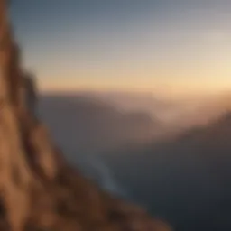 Silhouette of a person standing at a cliff edge looking at a vast horizon