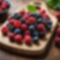 A vibrant assortment of colorful berries on a wooden cutting board