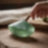 A close-up view of jade gua sha stone showcasing its natural green hues and texture.